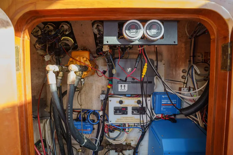 Solitude Yacht Photos Pics Electrical system inside a 1995 Prout 45 boat, featuring gauges and wiring.