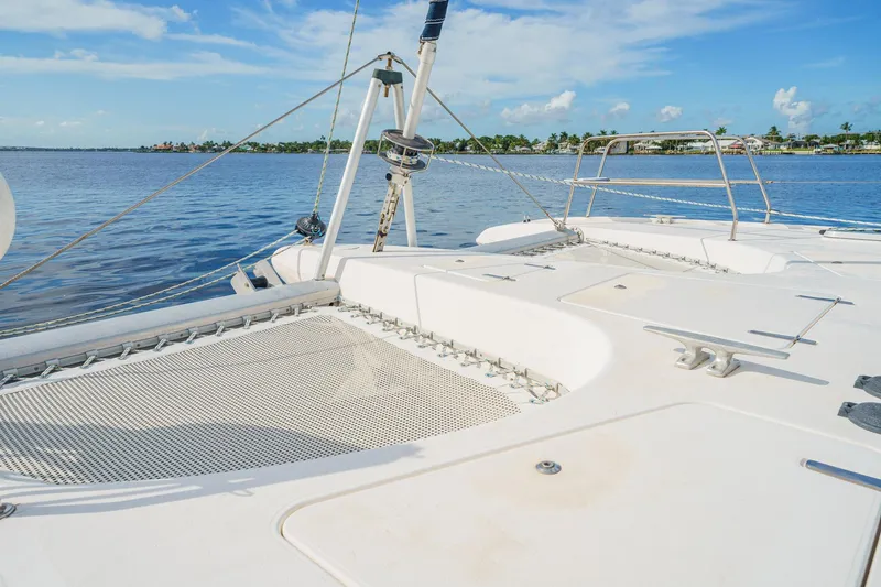 Solitude Yacht Photos Pics Deck view of a 1995 Prout 45 catamaran on calm waters under a blue sky.