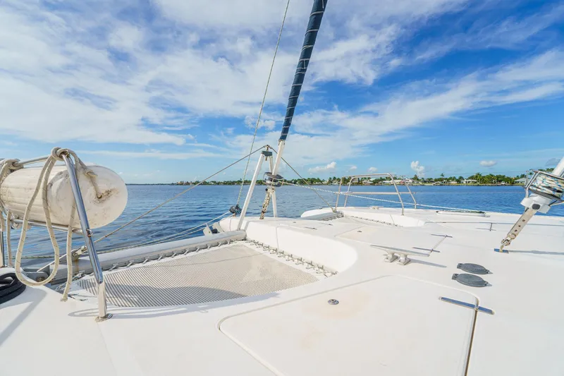 Solitude Yacht Photos Pics Sailing catamaran Prout 45, 1995 model, on calm waters under a clear blue sky.