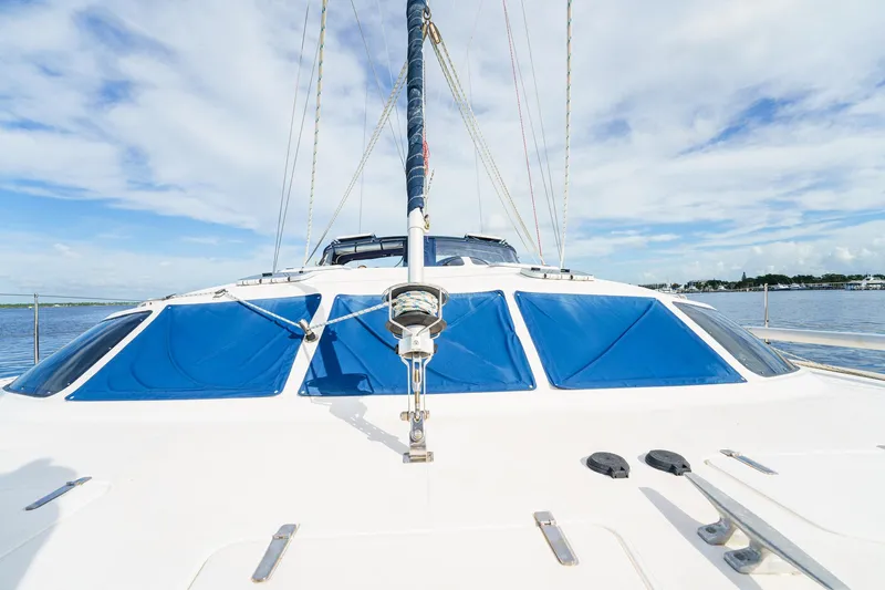 Solitude Yacht Photos Pics Sailing catamaran Prout 45, 1995 model, on calm waters under a blue sky.