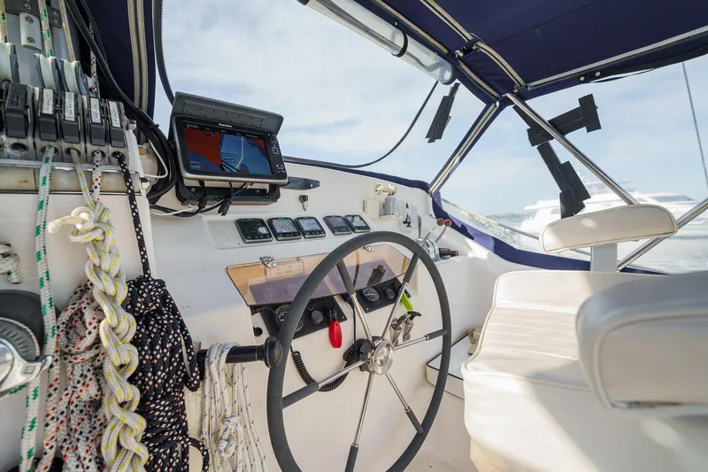 Solitude Yacht Photos Pics Cockpit of a 1995 Prout 45 sailboat with navigation equipment and steering wheel.