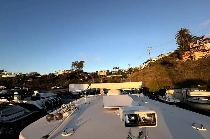 Killer B Yacht Photos Pics 2019 Grady-White Canyon 336 boat docked, scenic coastal view, clear sky.