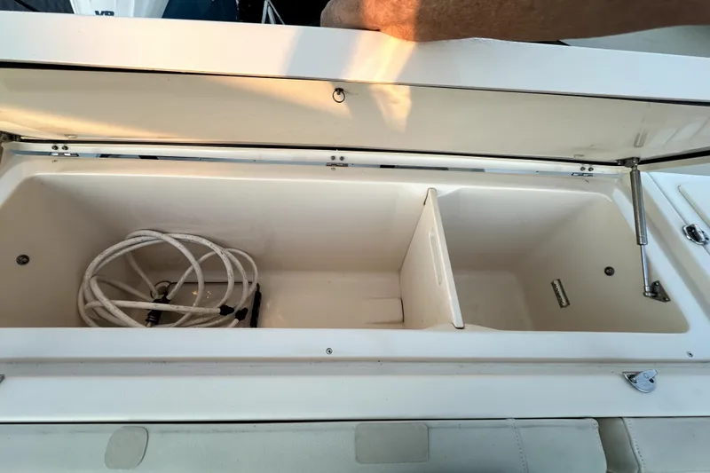Killer B Yacht Photos Pics Open storage compartment on 2019 Grady-White Canyon 336 boat with coiled hose inside.