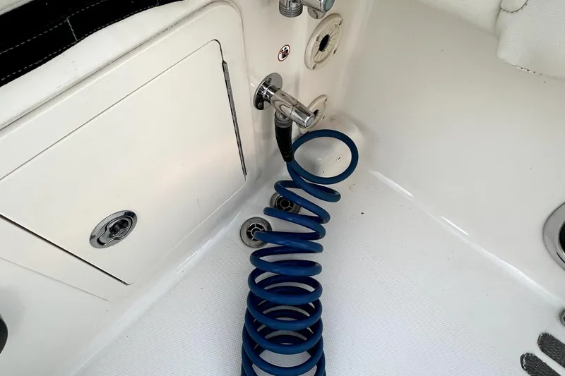 Killer B Yacht Photos Pics Coiled blue hose on 2019 Grady-White Canyon 336 boat deck near storage compartment.