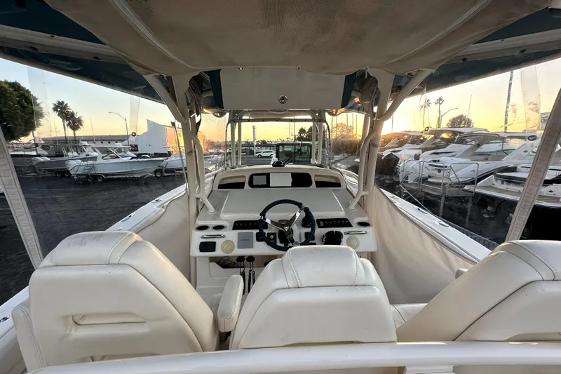 Killer B Yacht Photos Pics 2019 Grady-White Canyon 336 boat interior with helm, docked at sunset.