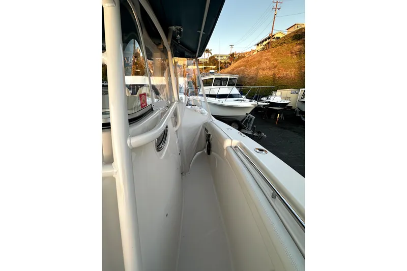 Killer B Yacht Photos Pics 2019 Grady-White Canyon 336 boat, side view, docked with other boats in the background.