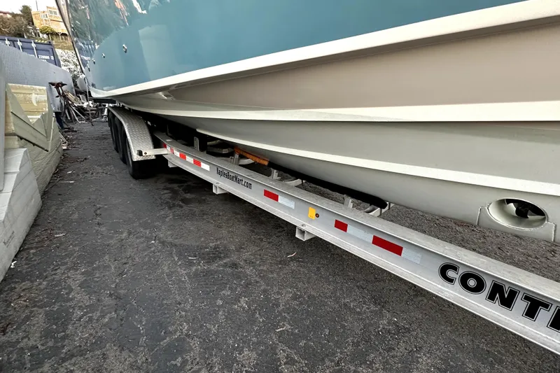 Killer B Yacht Photos Pics 2019 Grady-White Canyon 336 boat on trailer, parked on asphalt.