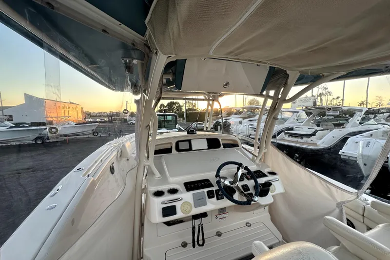Killer B Yacht Photos Pics 2019 Grady-White Canyon 336 boat interior with steering wheel at sunset.
