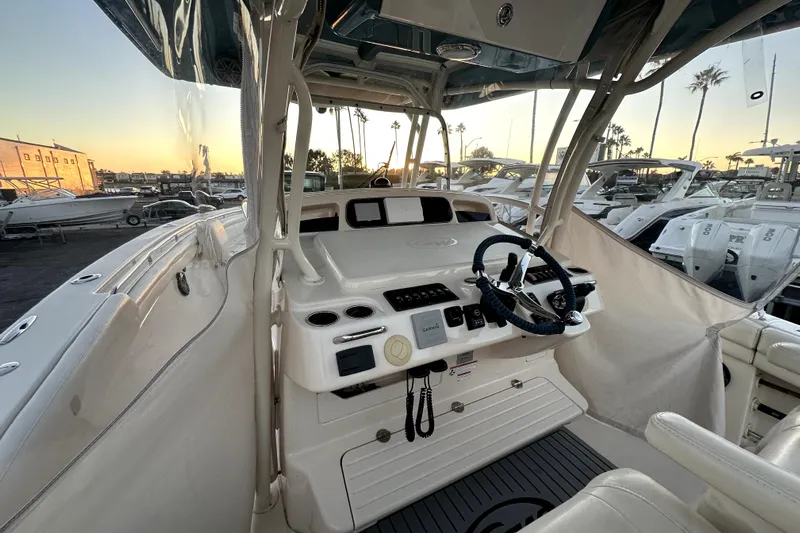 Killer B Yacht Photos Pics 2019 Grady-White Canyon 336 boat interior with steering wheel and controls at sunset.