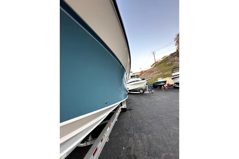 Killer B Yacht Photos Pics 2019 Grady-White Canyon 336 boat on trailer, side view in a marina setting.