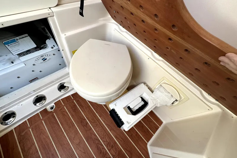 Killer B Yacht Photos Pics 2019 Grady-White Canyon 336 boat interior with toilet and storage compartment.