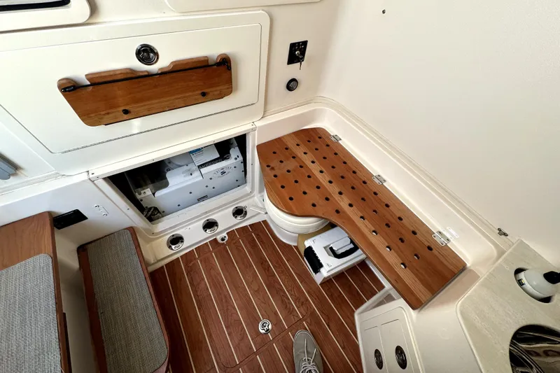 Killer B Yacht Photos Pics 2019 Grady-White Canyon 336 interior with wooden accents and storage compartments.