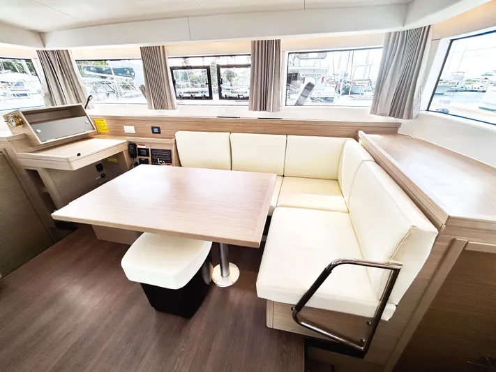 Cloud Walker Yacht Photos Pics Interior of 2024 Lagoon 40 catamaran with modern seating and dining area.