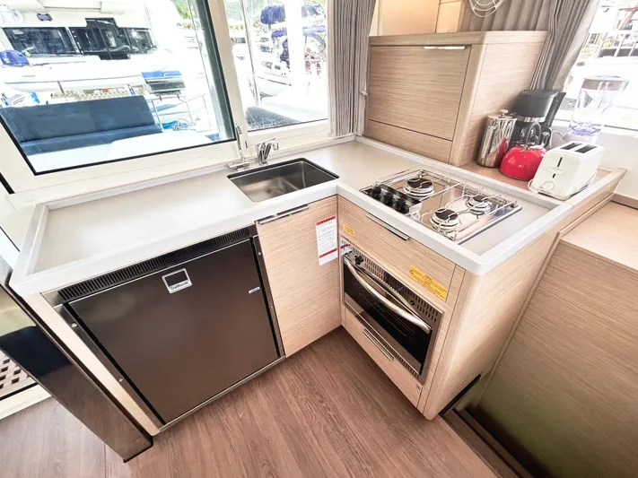 Cloud Walker Yacht Photos Pics Modern kitchen in 2024 Lagoon 40 yacht with stove, sink, and appliances.