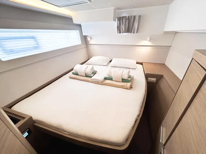 Cloud Walker Yacht Photos Pics Luxurious cabin interior of 2024 Lagoon 40 catamaran with cozy bedding and modern design.