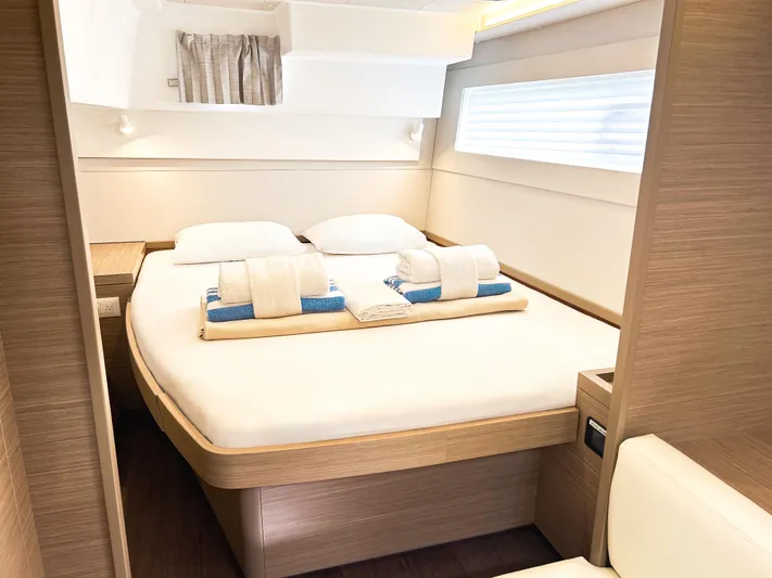 Cloud Walker Yacht Photos Pics 2024 Lagoon 40 yacht interior cabin with neatly arranged bed and modern design.