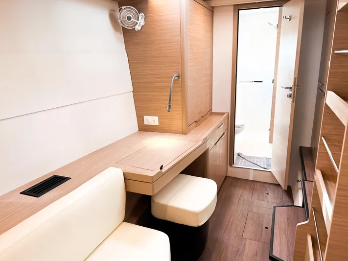 Cloud Walker Yacht Photos Pics 2024 Lagoon 40 yacht interior with modern wood finish and compact workspace.