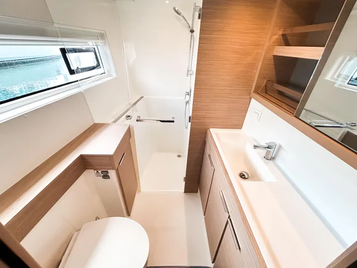 Cloud Walker Yacht Photos Pics Modern bathroom in 2024 Lagoon 40 yacht with sleek fixtures and wood accents.