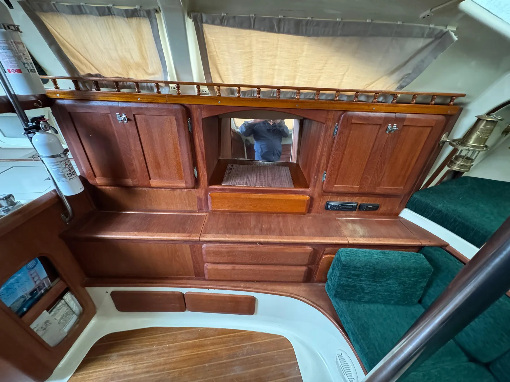 1994 Hunter 29.5 sailboat interior with wooden cabinets and green seating.