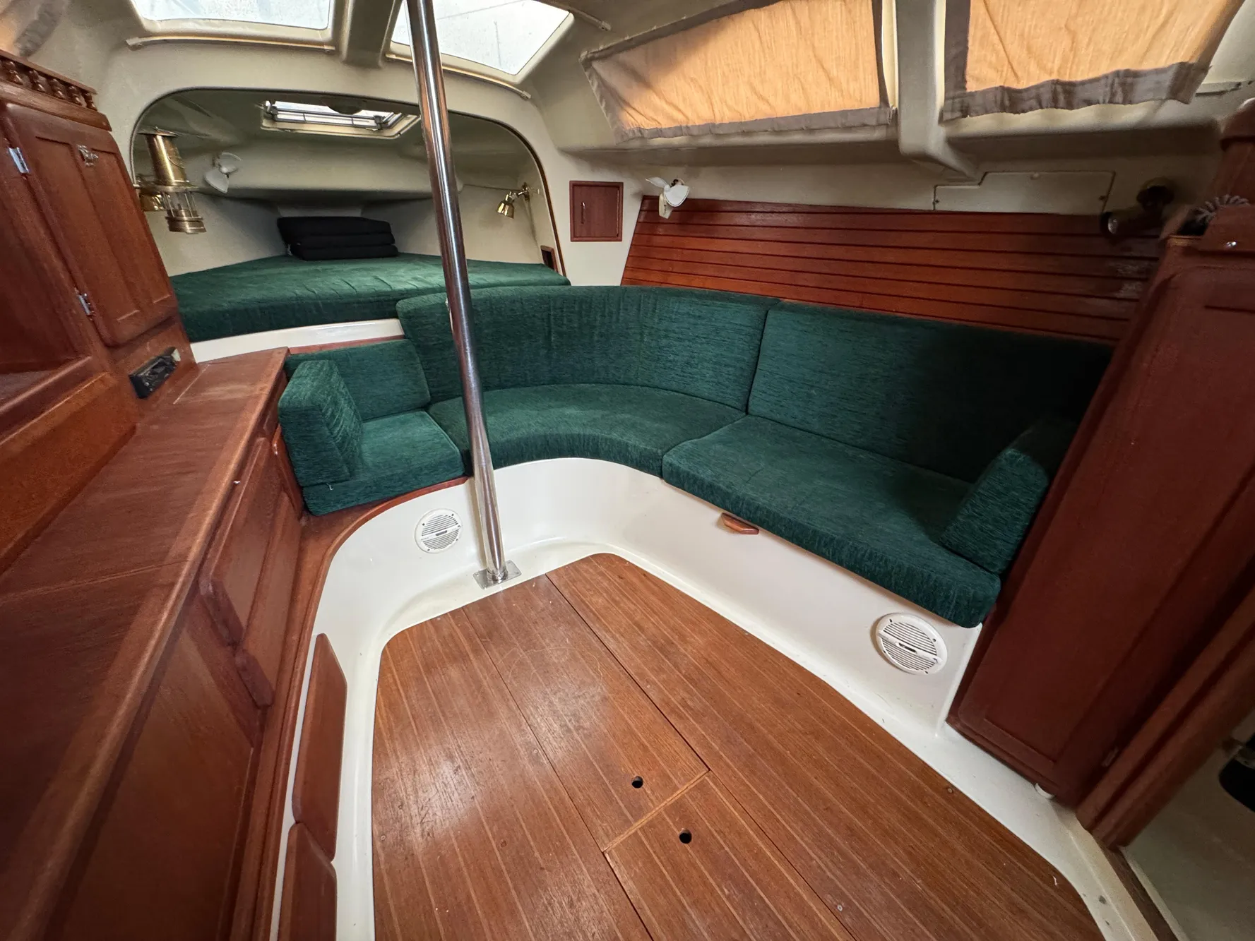 Interior of 1994 Hunter 29.5 sailboat with green seating and wood accents.