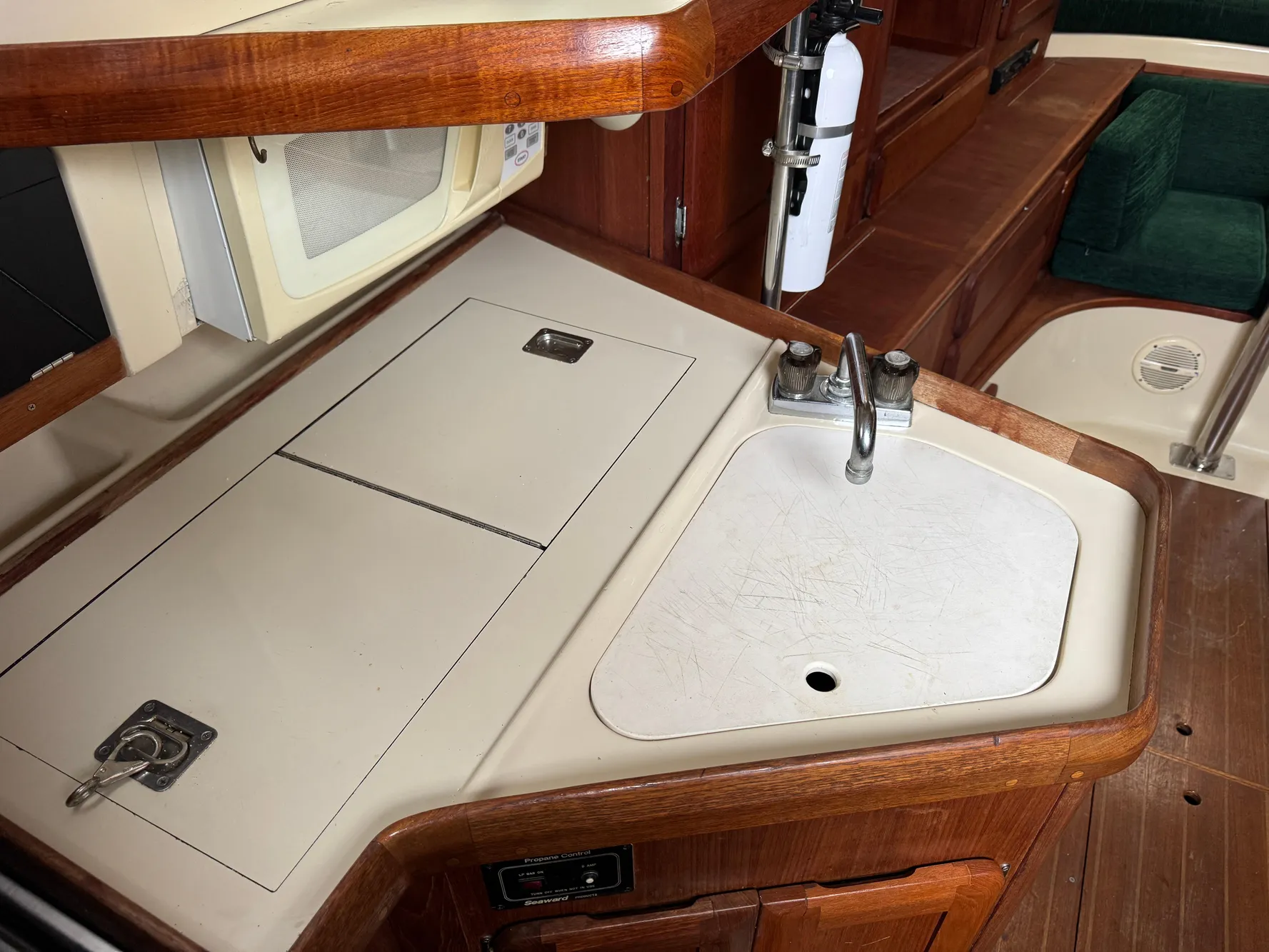 1994 Hunter 29.5 yacht interior kitchen with sink and wooden cabinetry.