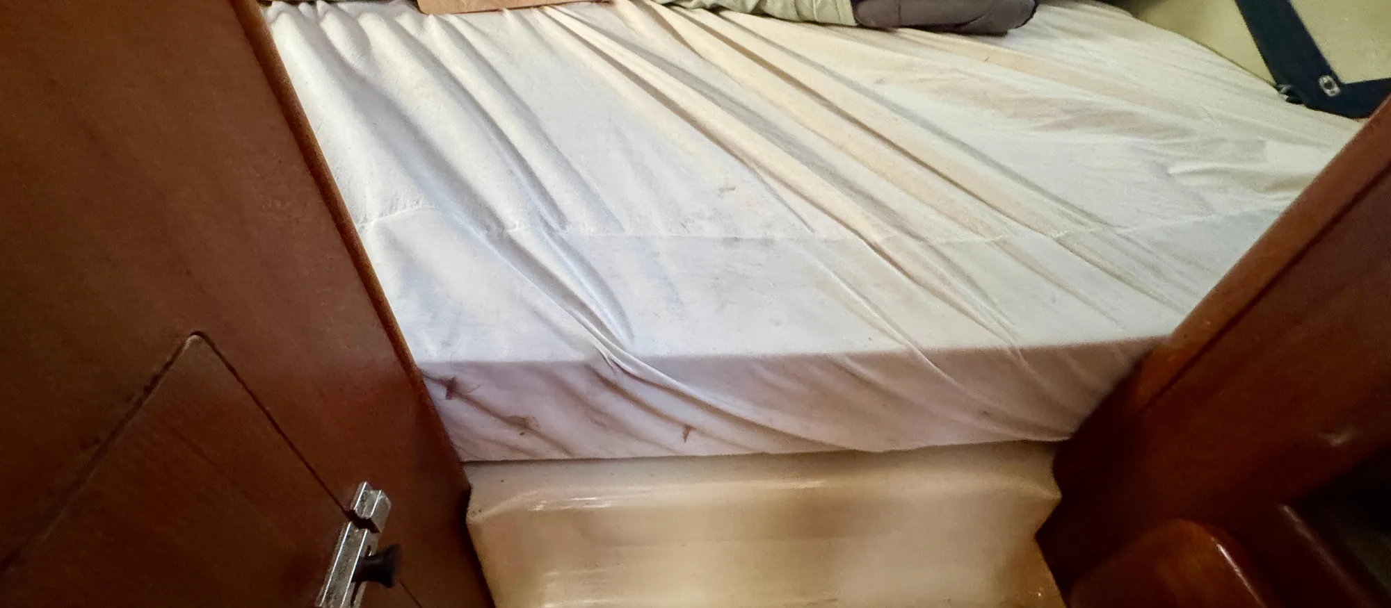 Interior cabin of 1994 Hunter 29.5 sailboat with bed and wooden paneling.