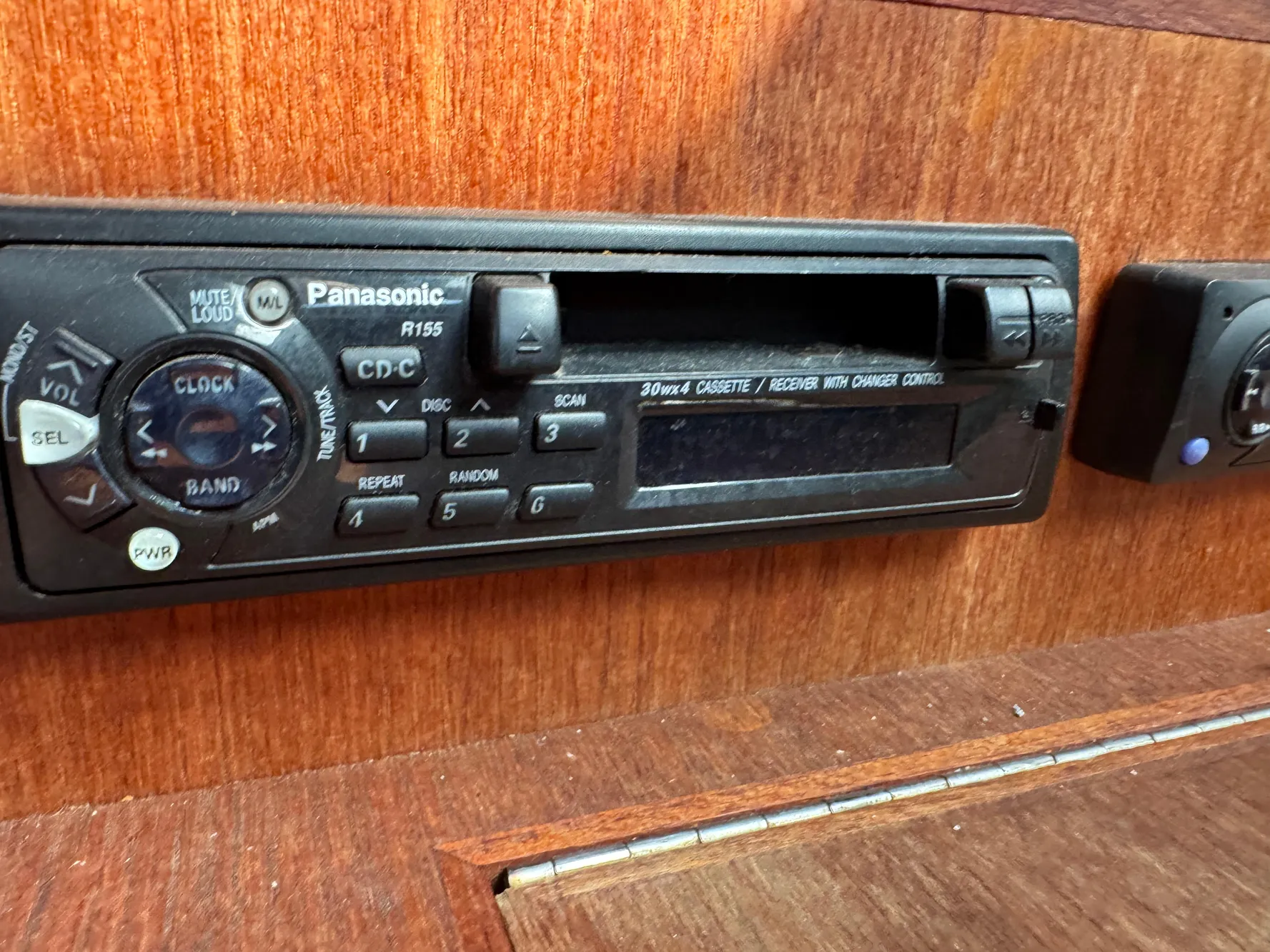 Panasonic cassette player in 1994 Hunter 29.5 boat interior, mounted on wooden panel.