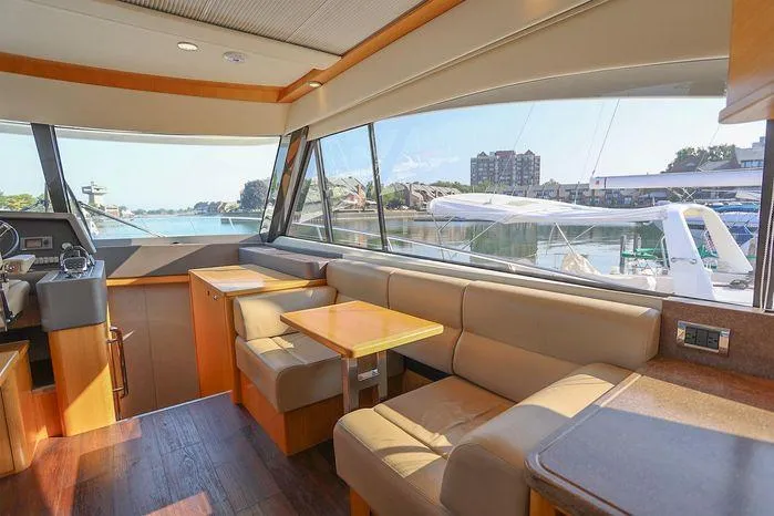 Eagle Yacht Photos Pics Interior of 2016 Riviera 525 SUV yacht with spacious seating and waterfront view.