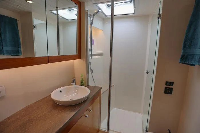 Eagle Yacht Photos Pics Luxurious bathroom in 2016 Riviera 525 SUV yacht with modern fixtures and glass shower.