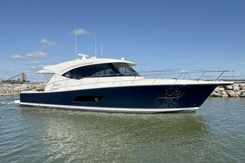 Eagle Yacht Photos Pics 2016 Riviera 525 SUV yacht cruising on calm waters under a clear blue sky.