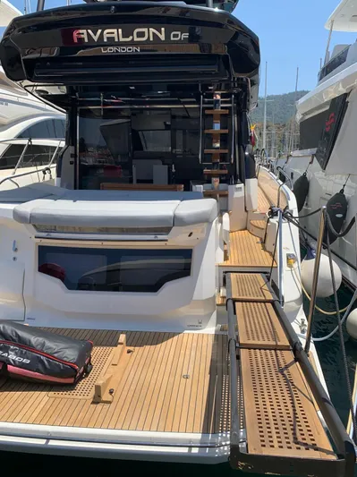  Yacht Photos Pics 2023 Cranchi E52F yacht docked, featuring spacious deck and modern design.