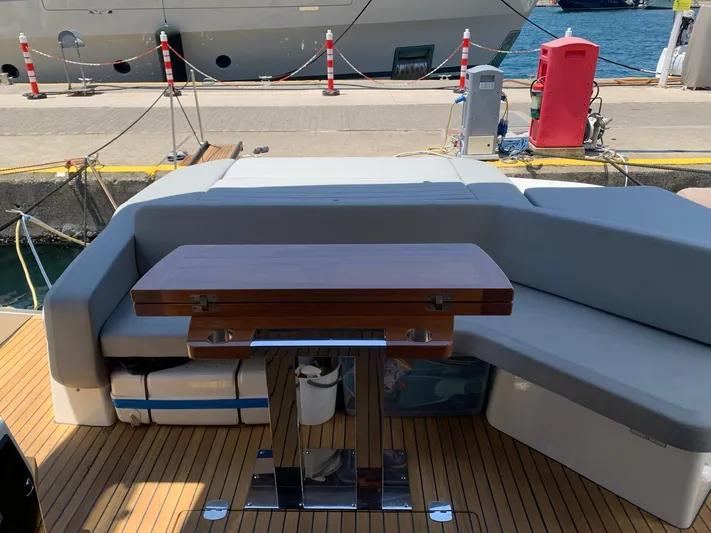  Yacht Photos Pics 2023 Cranchi E52F yacht deck with seating and wooden table.