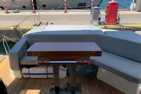 2023 Cranchi E52F yacht deck with seating and wooden table.