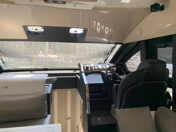  Yacht Photos Pics Interior of 2023 Cranchi E52F yacht, featuring modern helm and luxurious seating.