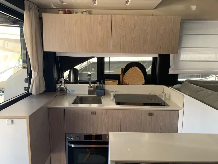  Yacht Photos Pics Modern kitchen interior of 2023 Cranchi E52F yacht with sleek cabinetry and appliances.