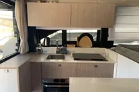 Modern kitchen interior of 2023 Cranchi E52F yacht with sleek cabinetry and appliances.
