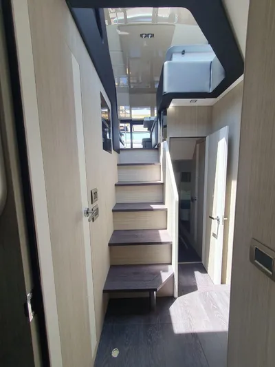  Yacht Photos Pics Interior view of 2023 Cranchi E52F yacht, featuring modern staircase and sleek design.