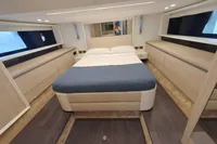 Luxurious bedroom interior of 2023 Cranchi E52F yacht with modern design and ample storage.
