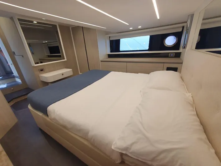 Yacht Photos Pics Luxurious bedroom interior of 2023 Cranchi E52F yacht with modern design and cozy bedding.