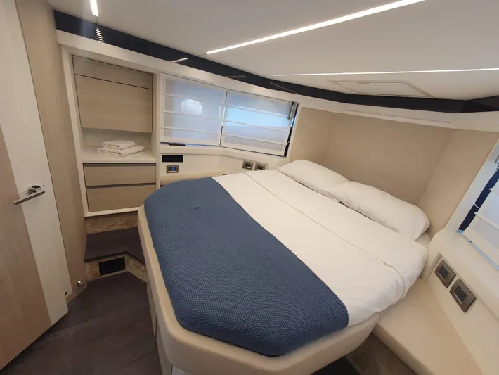  Yacht Photos Pics 2023 Cranchi E52F yacht bedroom with modern design and cozy bedding.