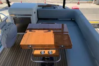 Luxurious 2023 Cranchi E52F yacht deck with elegant wooden table and seating area.