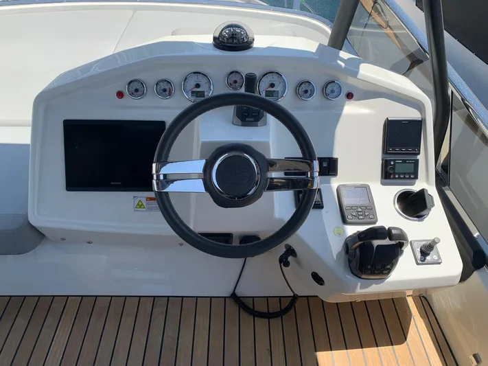  Yacht Photos Pics Helm of 2023 Cranchi E52F yacht with modern controls and instruments.