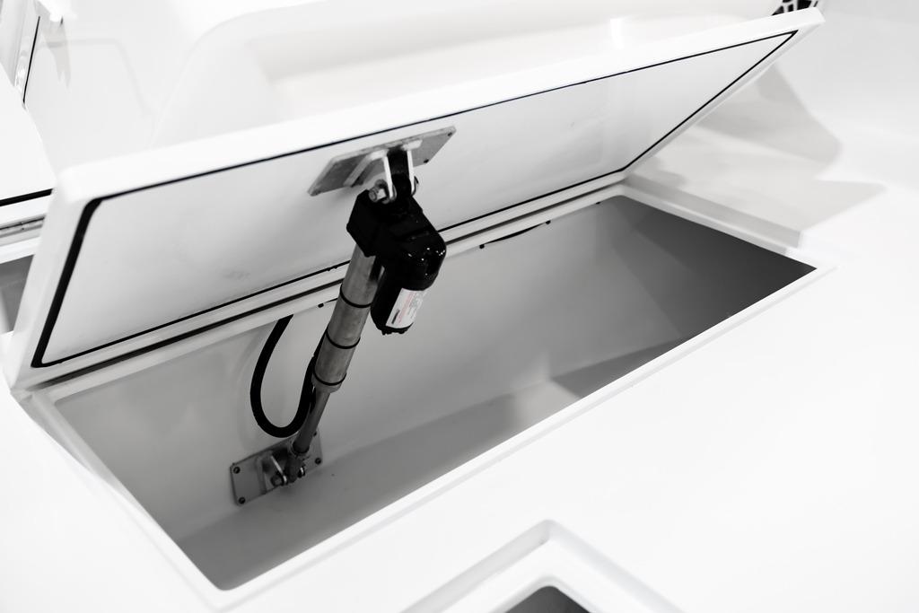 Open storage compartment on 2026 Contender 28 Tournament boat, showcasing interior details.