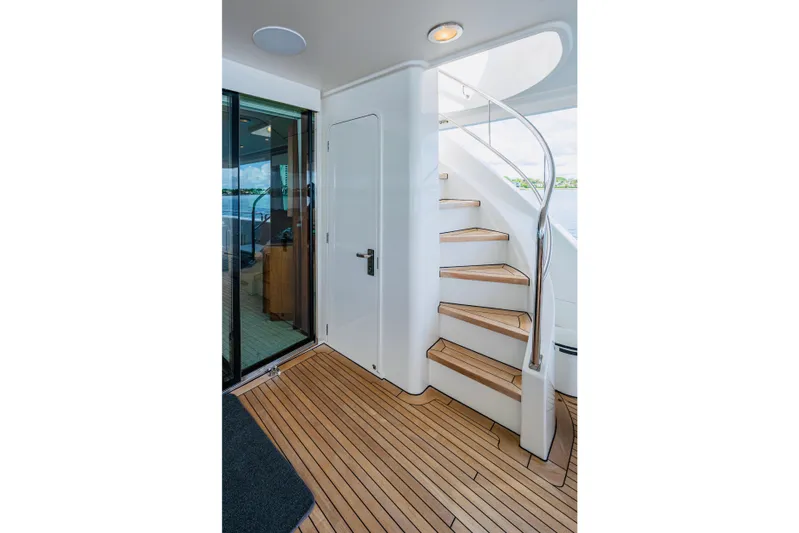 Lila Cuy Yacht Photos Pics Luxurious Westport w112 yacht interior with spiral staircase, teak flooring, and glass door, 2006 model.