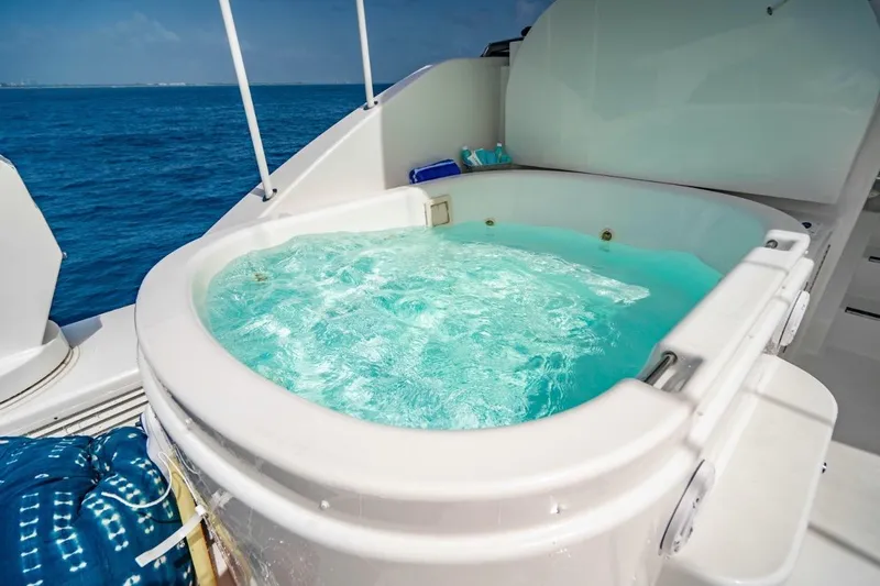 Lila Cuy Yacht Photos Pics Luxurious hot tub on 2006 Westport w112 yacht, overlooking serene ocean waters.