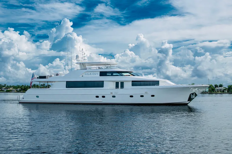 Lila Cuy Yacht Photos Pics Luxury Westport w112 yacht from 2006 on calm water under a cloudy sky.