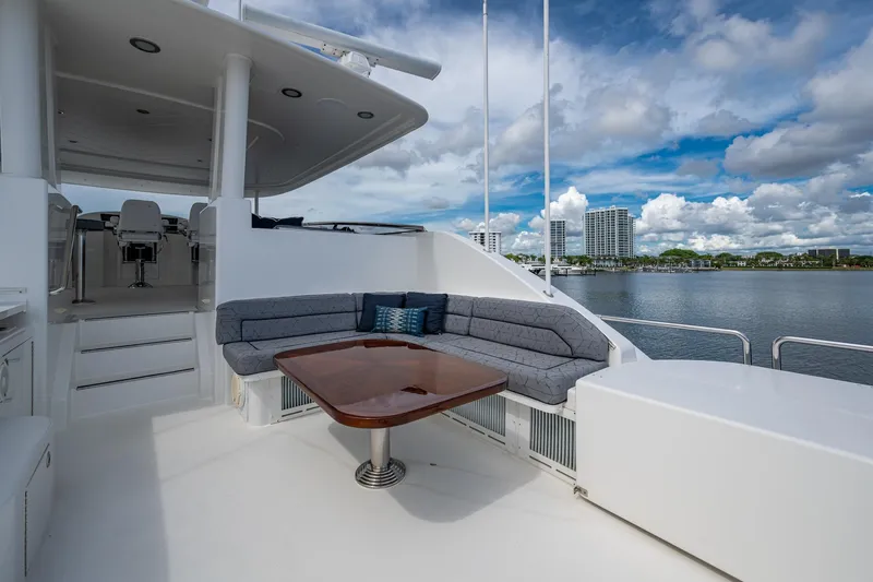 Lila Cuy Yacht Photos Pics Luxurious 2006 Westport w112 yacht deck with seating, table, and waterfront view.