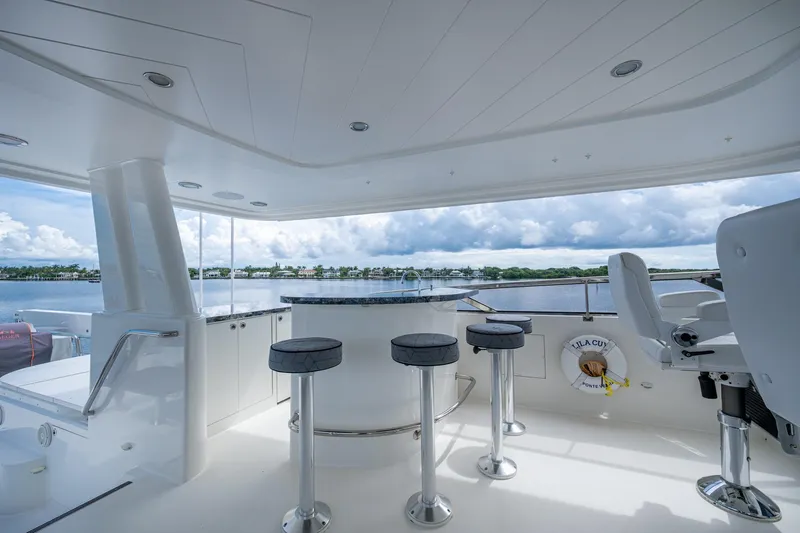 Lila Cuy Yacht Photos Pics Luxurious 2006 Westport w112 yacht interior with bar stools and scenic water view.
