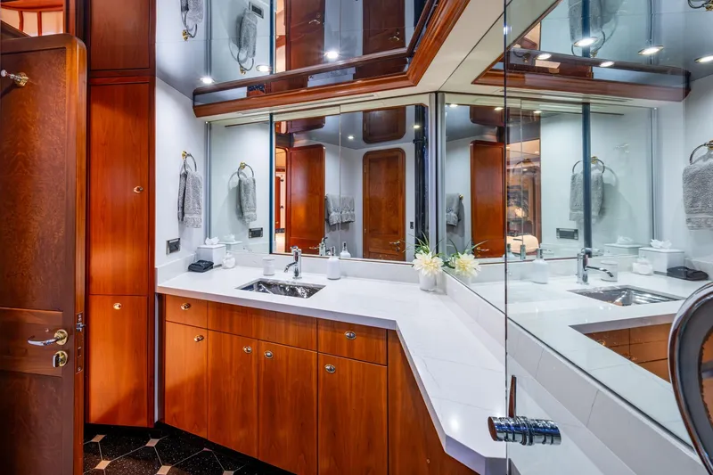 Lila Cuy Yacht Photos Pics Luxurious yacht bathroom with wooden cabinetry, large mirrors, and elegant fixtures, Westport w112, 2006.