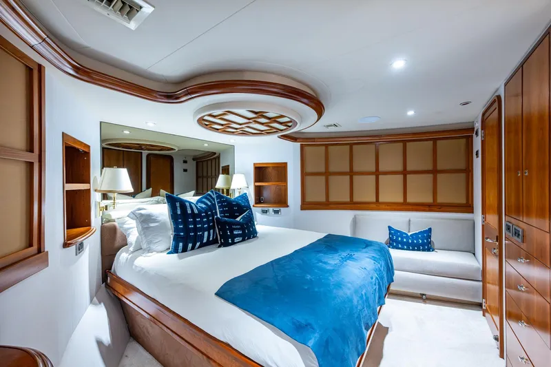 Lila Cuy Yacht Photos Pics Luxurious 2006 Westport w112 yacht bedroom with elegant wood accents and blue decor.